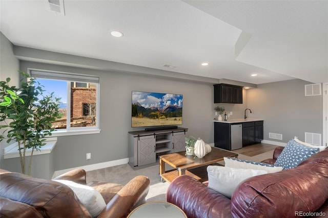 living room featuring light hardwood / wood-style floors and sink