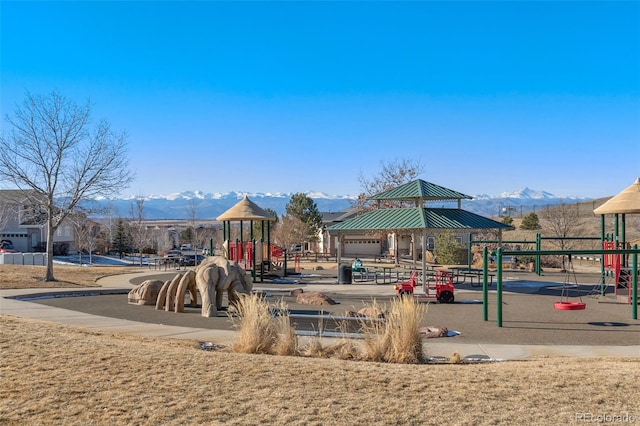 view of jungle gym with a lawn, a gazebo, and a mountain view