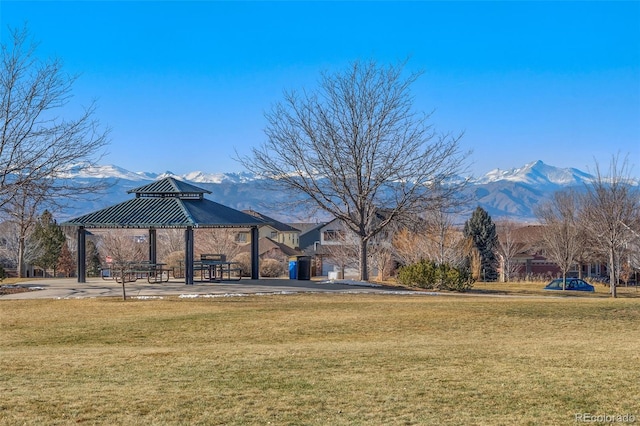 view of community with a gazebo, a mountain view, and a yard