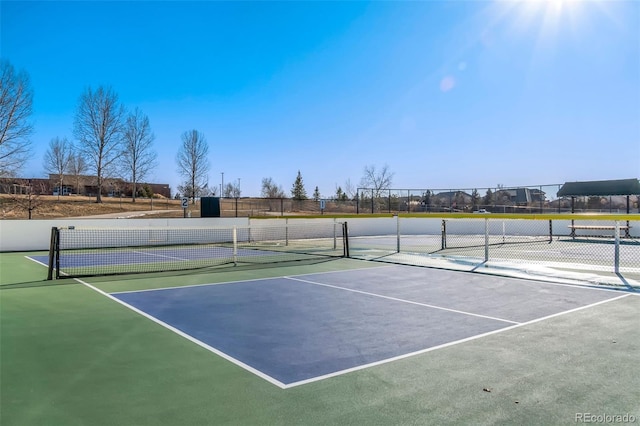 view of tennis court featuring basketball hoop