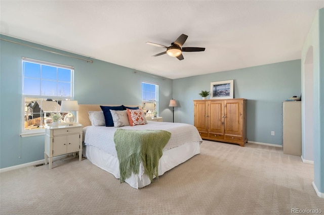 bedroom with ceiling fan and light colored carpet