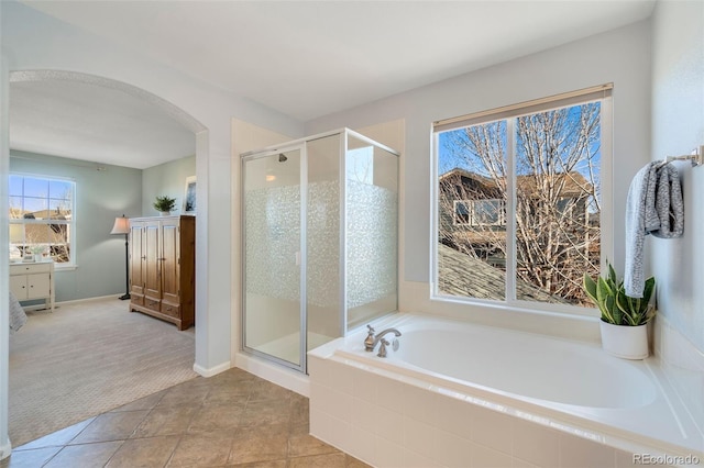 bathroom featuring shower with separate bathtub