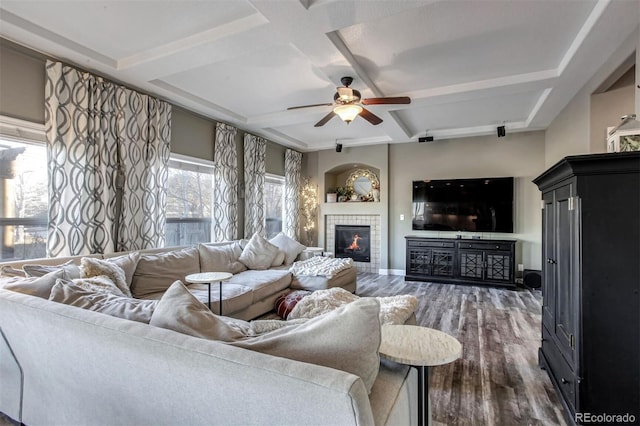 living room with ceiling fan, dark wood-type flooring, and a wealth of natural light