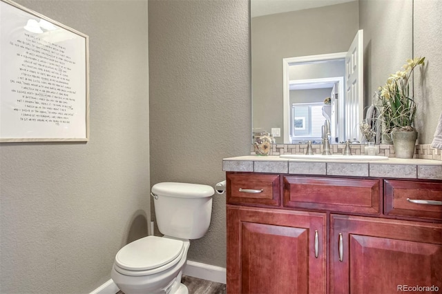 bathroom with toilet and vanity