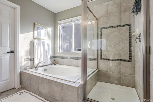 bathroom with separate shower and tub and tile patterned flooring