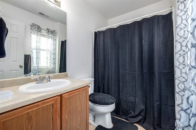 bathroom featuring toilet and vanity