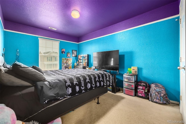 carpeted bedroom featuring a textured ceiling