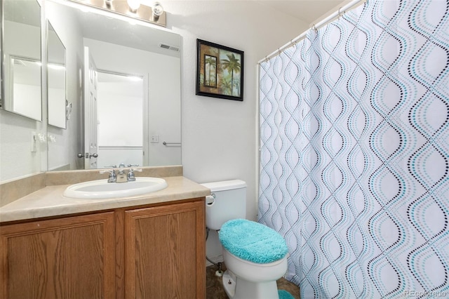 bathroom with walk in shower, vanity, and toilet