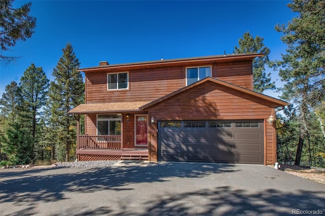 front of property featuring a porch and a garage