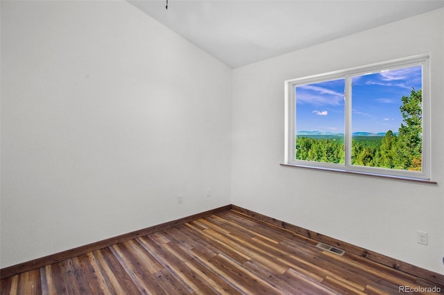 spare room featuring dark hardwood / wood-style flooring