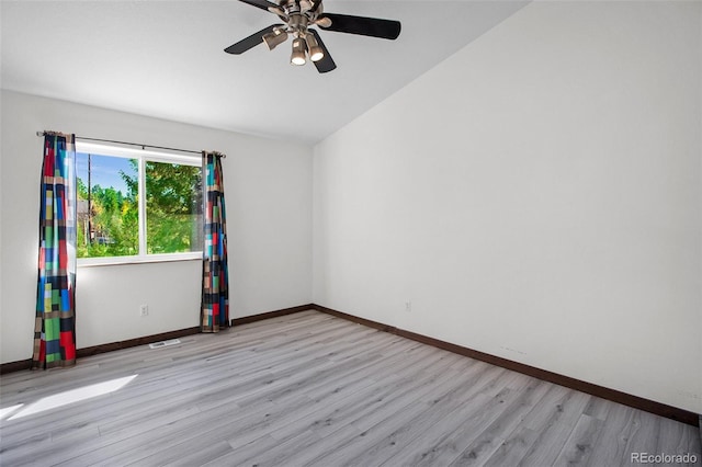 unfurnished room with ceiling fan, light wood-type flooring, and vaulted ceiling