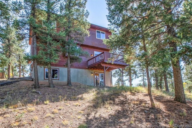 rear view of house with a wooden deck