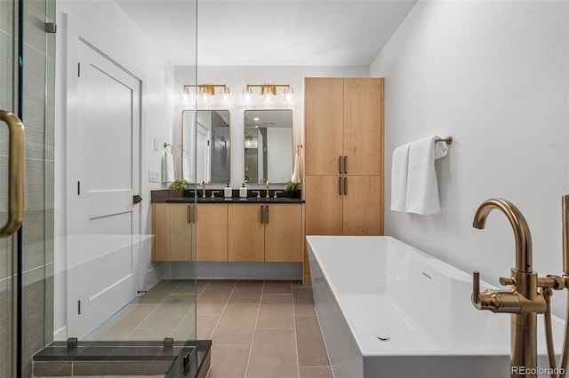 bathroom with tile patterned flooring, vanity, and a bathtub