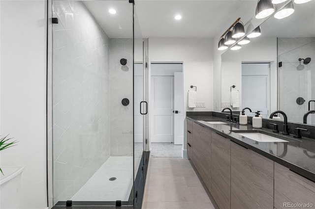 bathroom featuring vanity and an enclosed shower