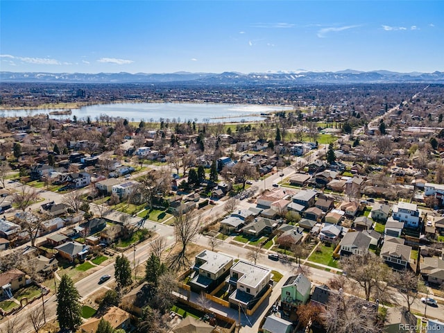 drone / aerial view with a water and mountain view