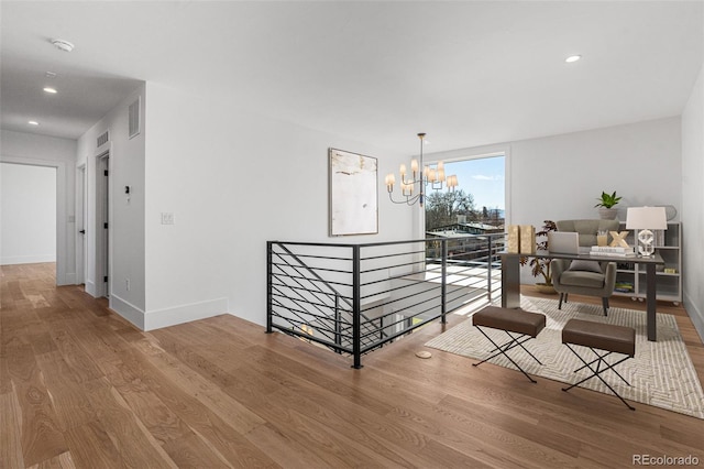 interior space with a chandelier and wood-type flooring