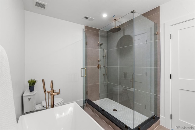 bathroom with a shower with door and toilet