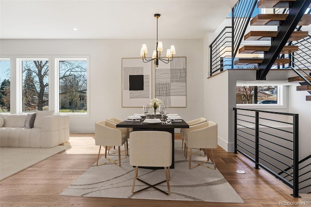 dining area featuring an inviting chandelier and hardwood / wood-style floors