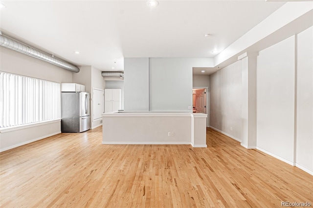 unfurnished living room featuring light wood-type flooring