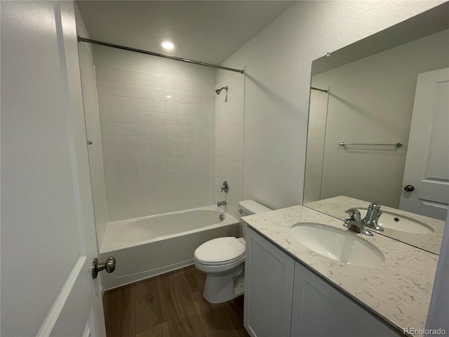 bathroom featuring shower / bath combination, toilet, vanity, and wood finished floors