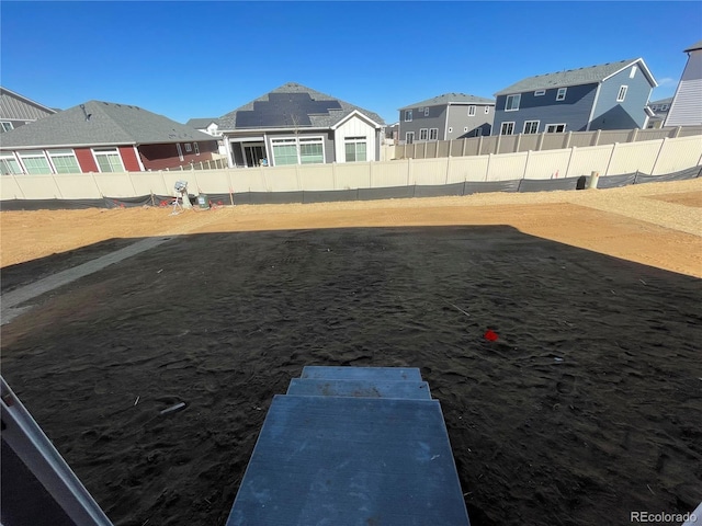 view of yard featuring a residential view and a fenced backyard