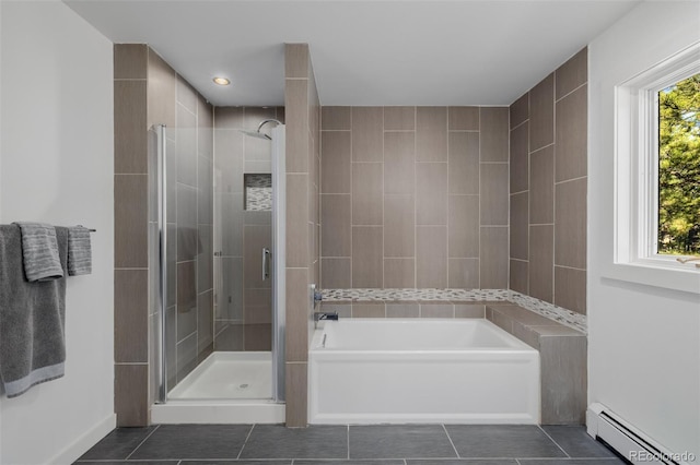 full bathroom with a baseboard heating unit, tile patterned floors, a shower stall, baseboards, and a bath