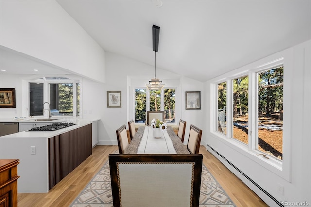 dining space with a baseboard heating unit, recessed lighting, lofted ceiling, and light wood-type flooring
