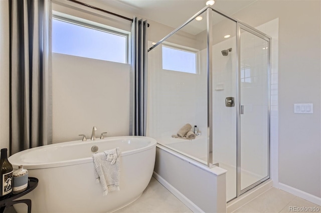 1320 Loraine Cir N, Lafayette, CO 80026 - full bath featuring a soaking tub, a shower stall, baseboards, and tile patterned floors