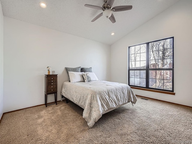 bedroom with lofted ceiling, a textured ceiling, light carpet, visible vents, and baseboards