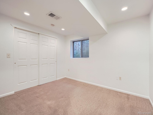 unfurnished bedroom with baseboards, visible vents, carpet flooring, a closet, and recessed lighting