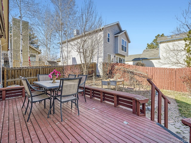 deck featuring outdoor dining space and fence