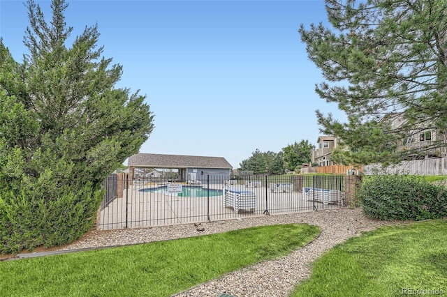 pool with a patio and fence