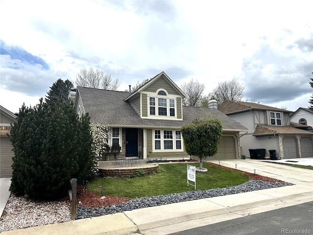 view of front of property featuring a front lawn, concrete driveway, a shingled roof, and a garage