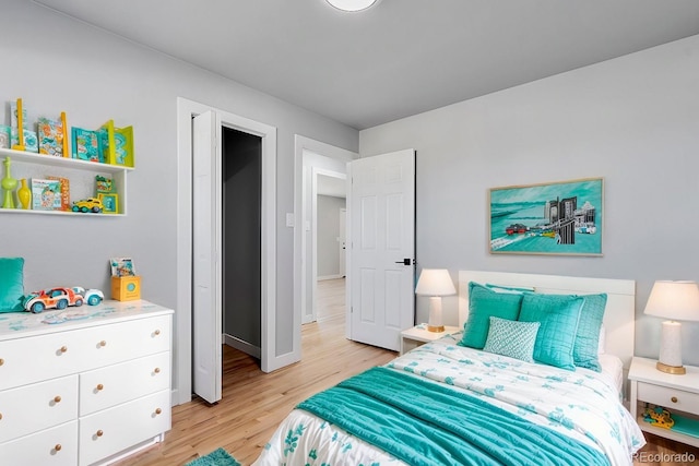 bedroom with baseboards and light wood-style floors