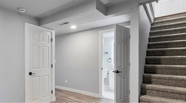 interior space with light wood finished floors, visible vents, baseboards, stairs, and recessed lighting