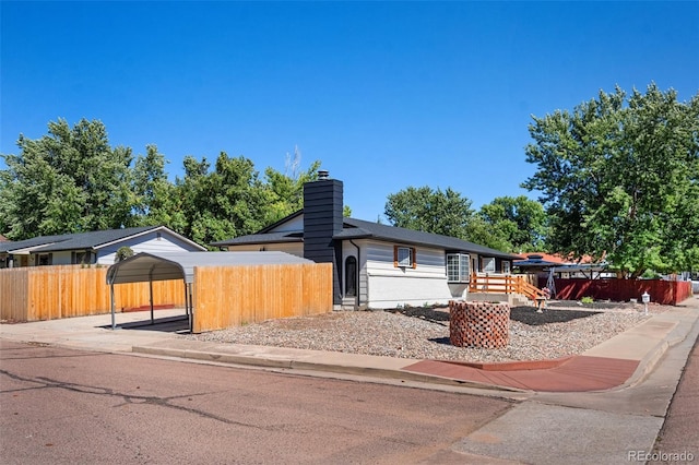 ranch-style house featuring a carport