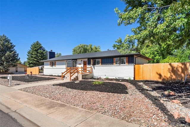 single story home with a garage and an outbuilding