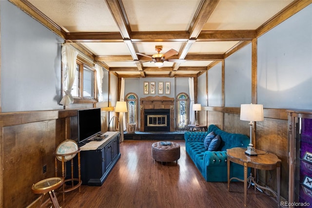 living room with beam ceiling, ceiling fan, dark hardwood / wood-style floors, and coffered ceiling