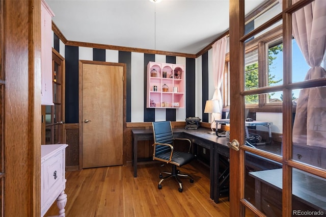 office space featuring light wood-type flooring and ornamental molding