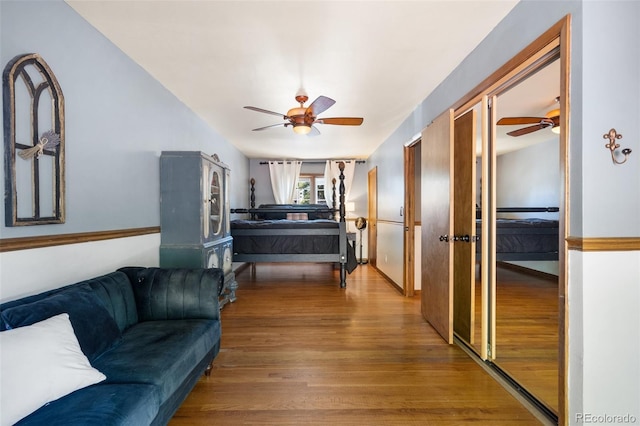 living room with ceiling fan and wood-type flooring