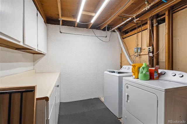 washroom with cabinets and separate washer and dryer