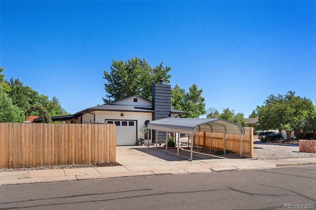 view of front facade with a garage and a carport