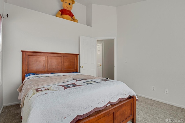 bedroom with light carpet and baseboards