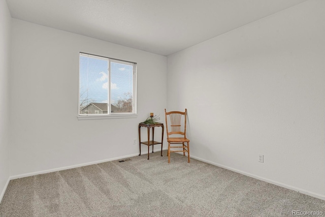 living area with carpet flooring, visible vents, and baseboards