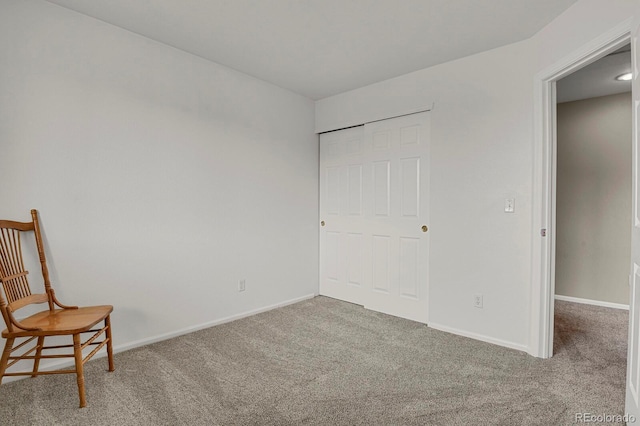 interior space with carpet flooring and baseboards