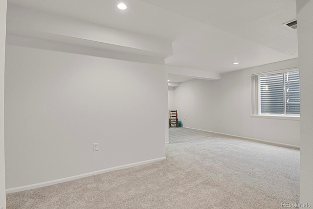 unfurnished room featuring recessed lighting, light colored carpet, visible vents, and baseboards