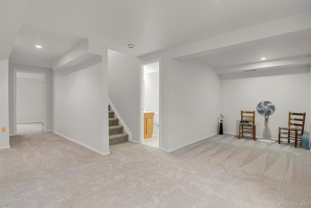 finished basement featuring recessed lighting, baseboards, stairway, and light colored carpet