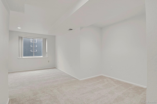 spare room with light carpet, visible vents, baseboards, and recessed lighting