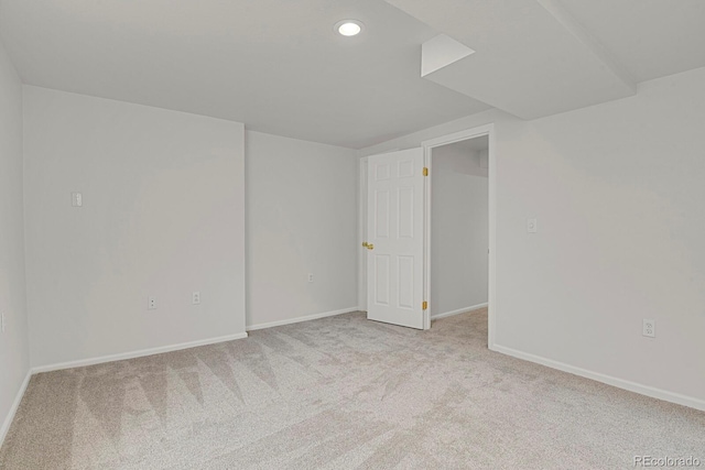 empty room with light carpet, recessed lighting, and baseboards