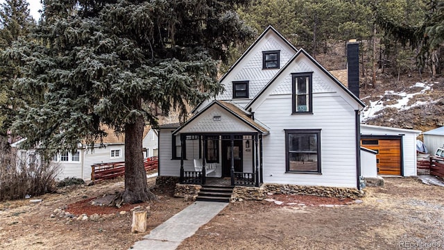 view of front of home featuring a porch and a garage